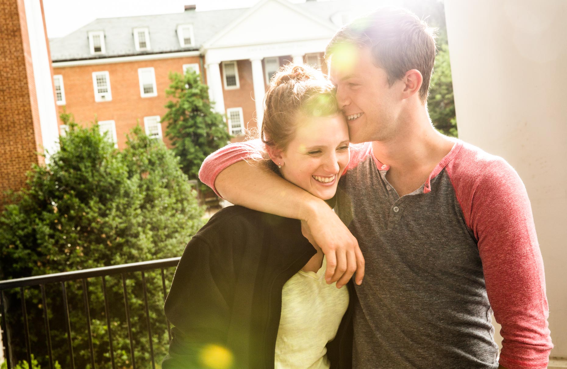 Man and women hugging on balcony
