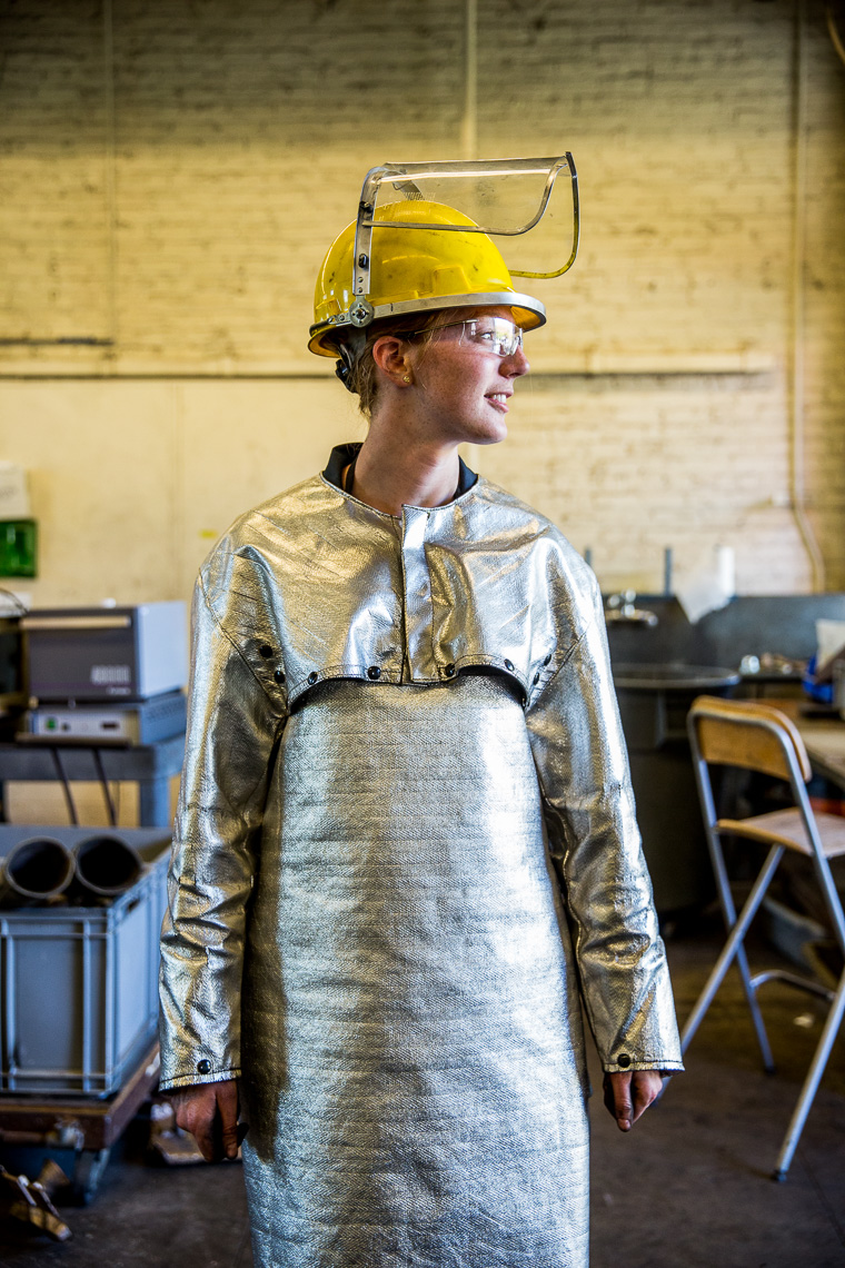 Female college student in welding shop.