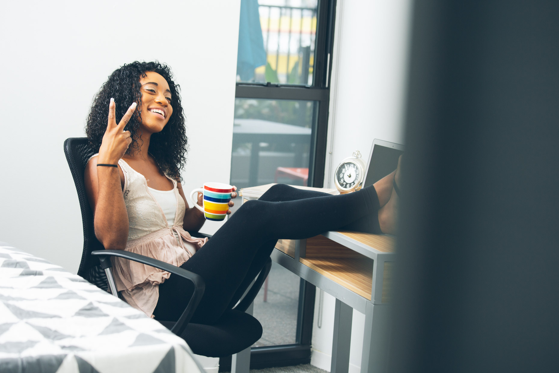 A college student hanging out in dorm room.