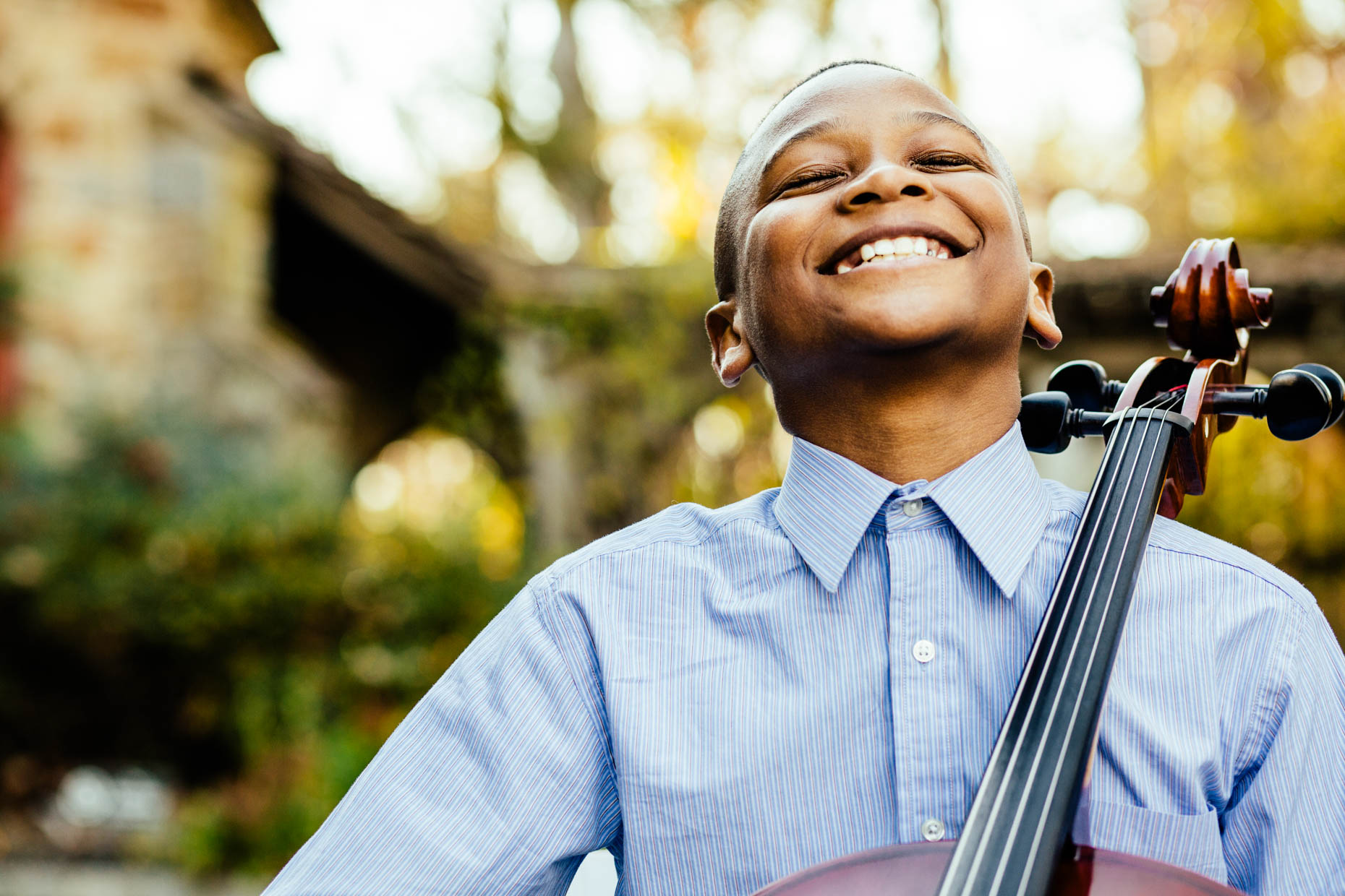 Portrait of boy laughing with Cello