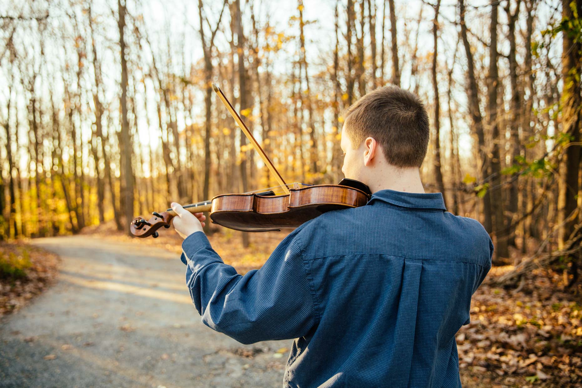Boy playing violin outside