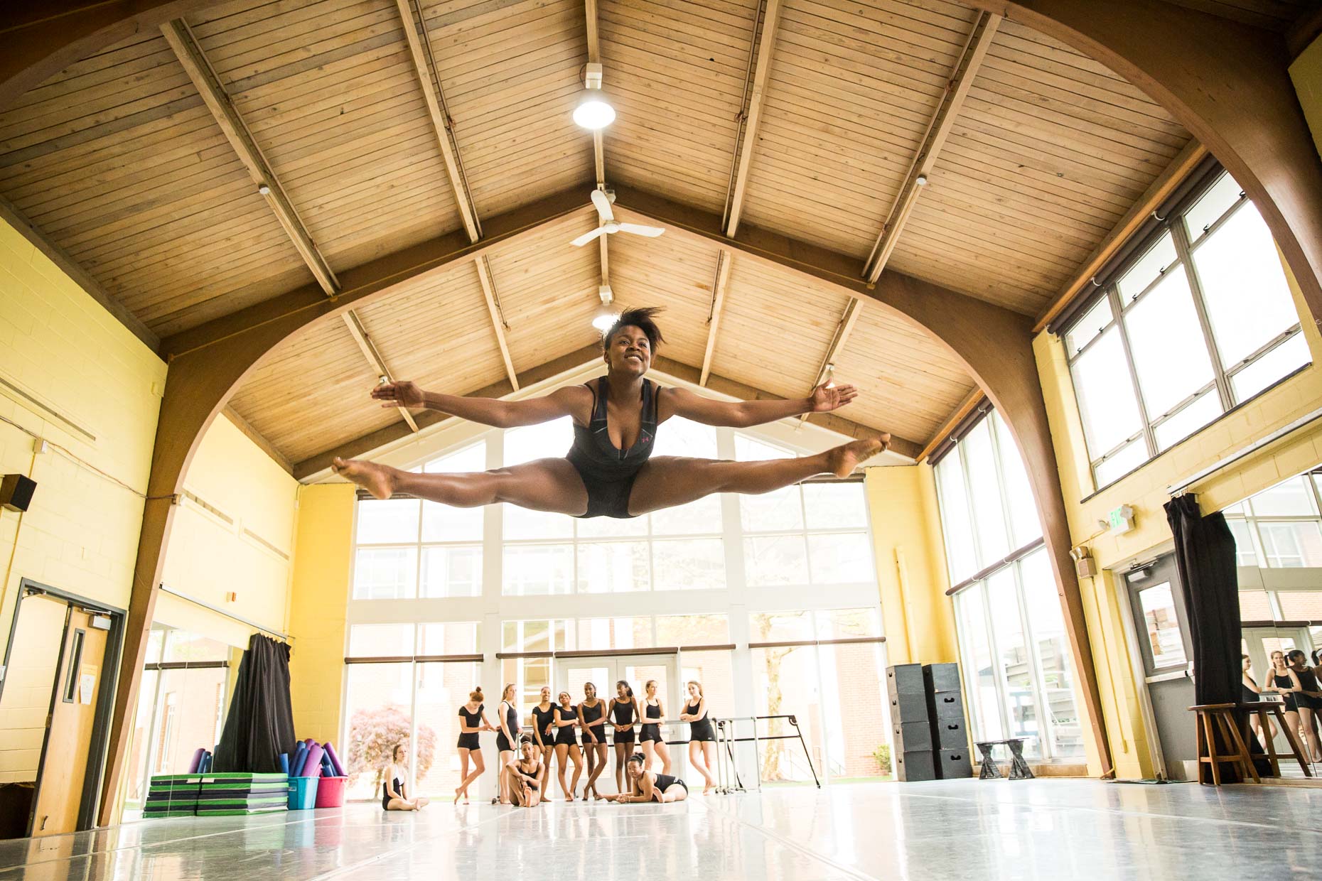 Female Ballet dancer jumping in dance studio.