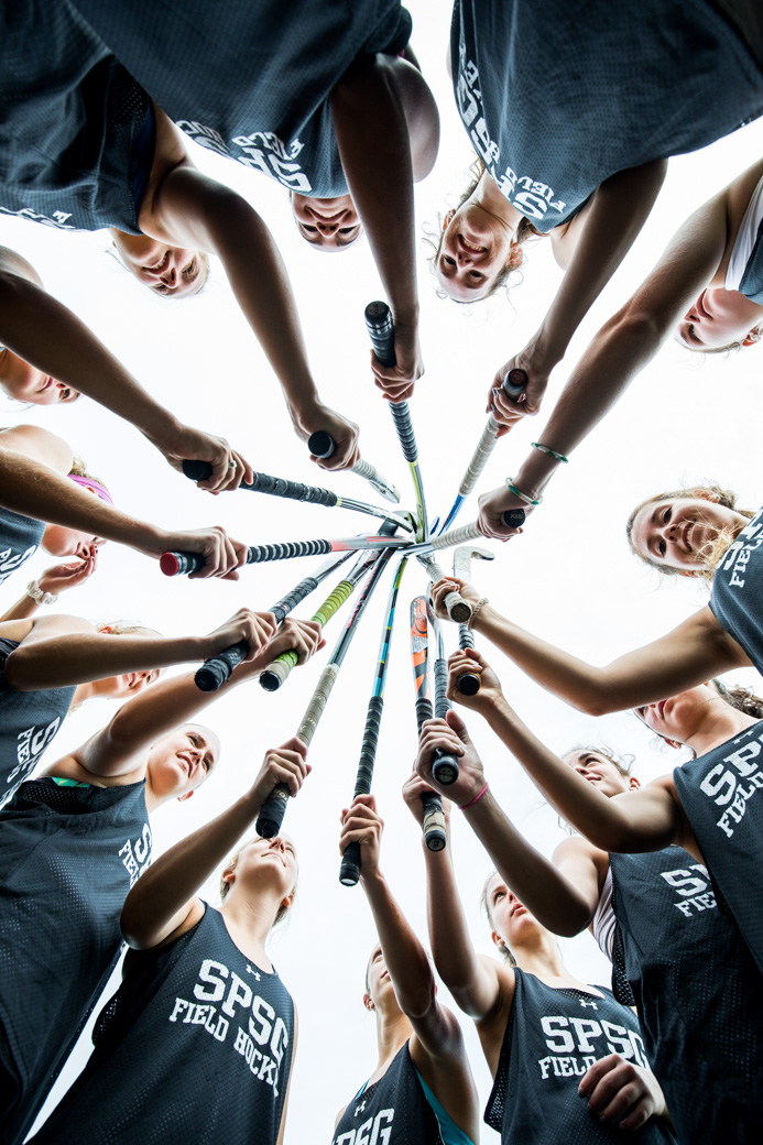 Girls Field Hockey team huddle.