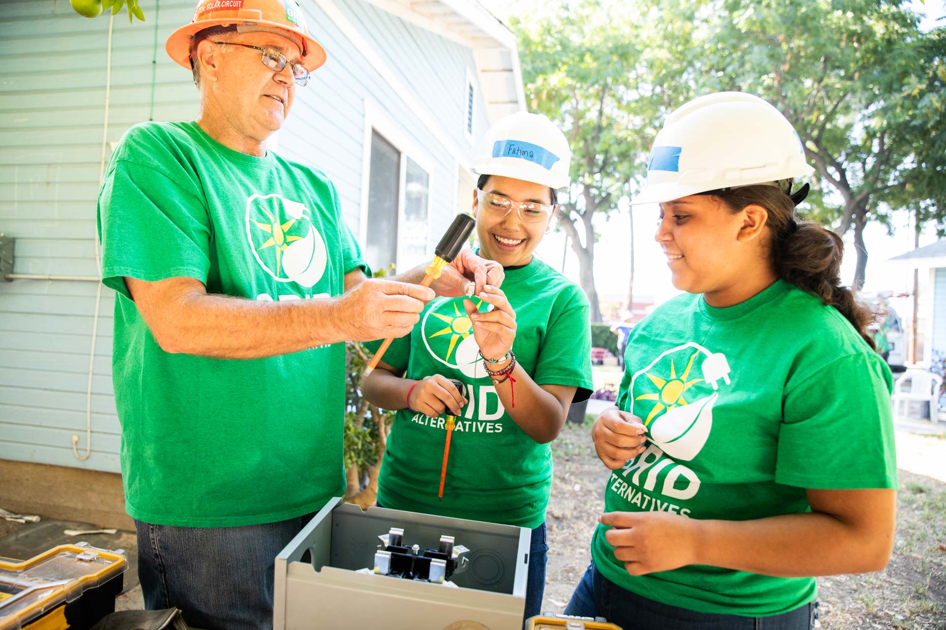 Young volunteers in hard hats.