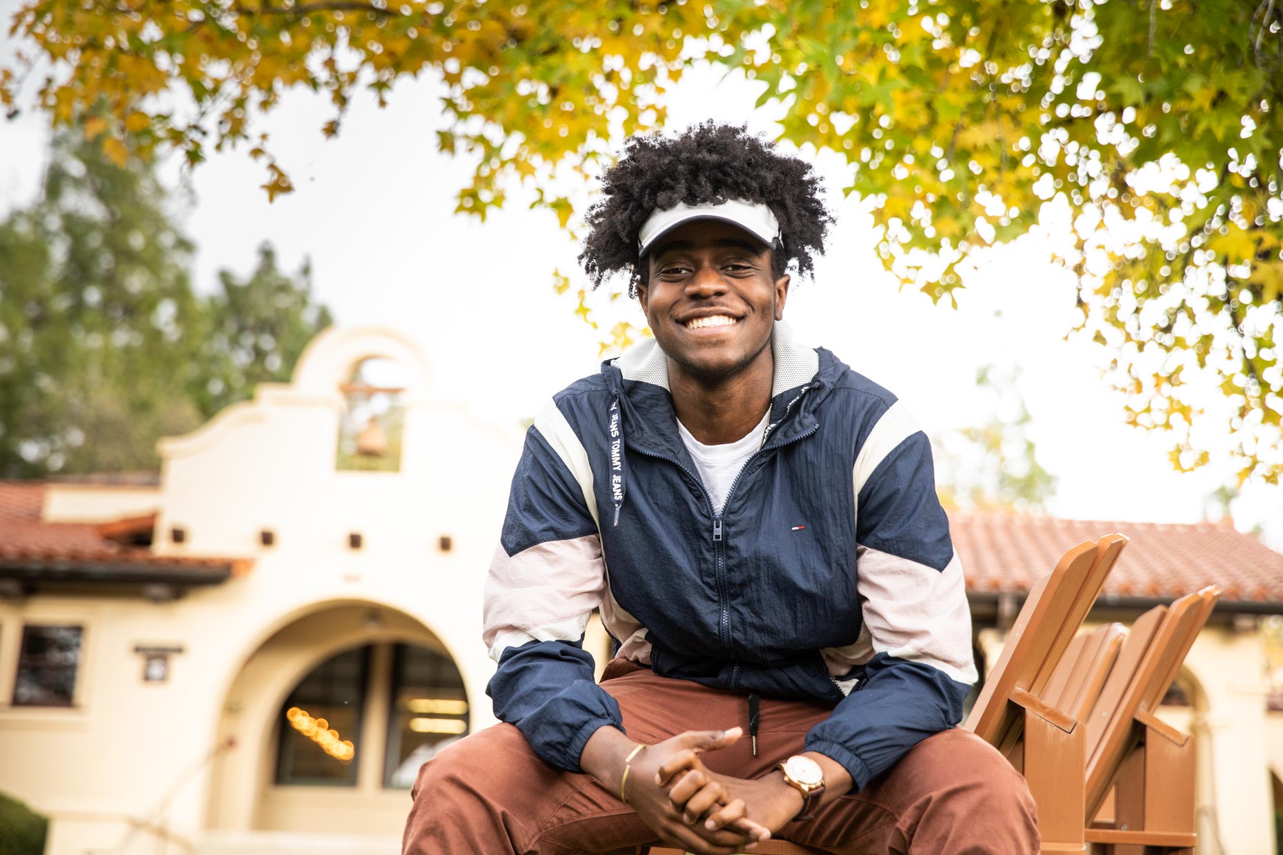Portrait of smiling African American student with visor.